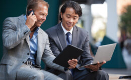 Businessmen using electronic gadgets